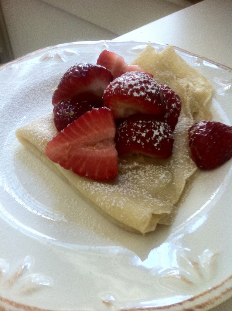 crepes with fresh strawberries, lemon zest and powdered sugar